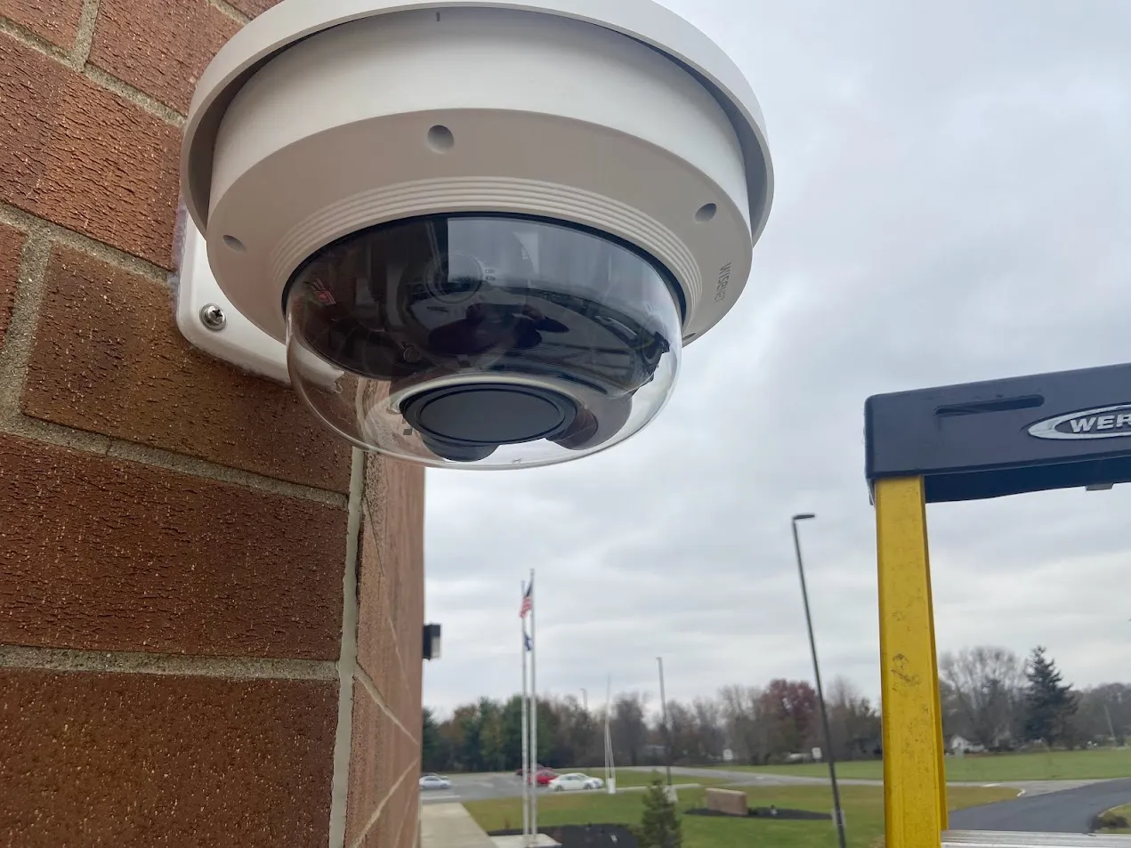 Exterior dome security camera installed by Pinnacle Systems on a school building